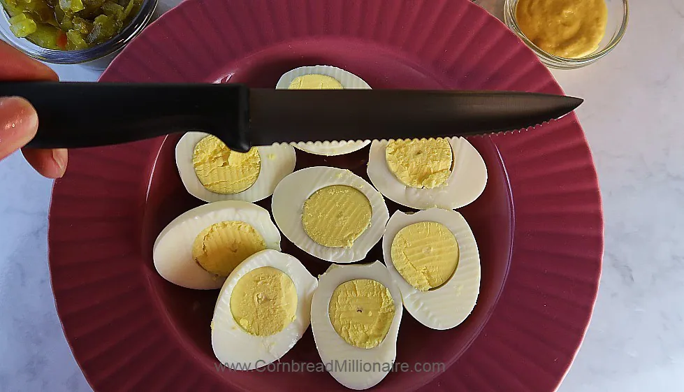 Use a serrated knife to slice hard boiled eggs.