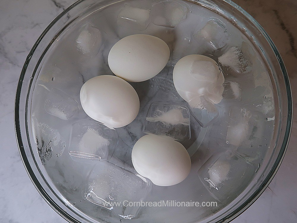 Place hard boiled eggs in bowl filled with ice cubes and cold water.  Make sure each egg is totally submerged. 